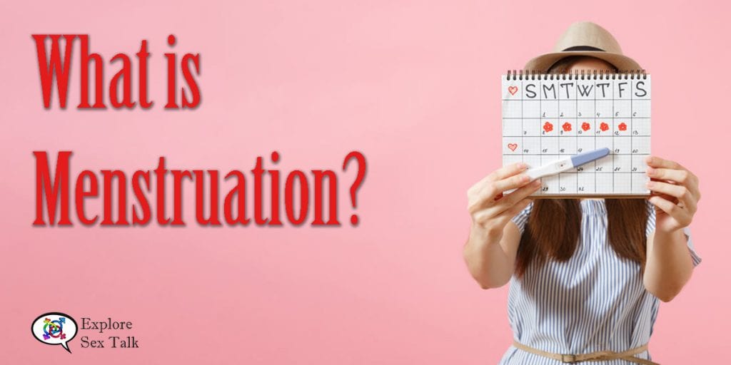 what is menstruation - woman holding up calendar and pregnancy test